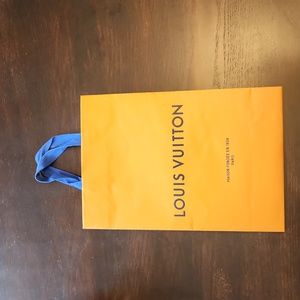 Louis Vuitton gift bag. It's 14X10X4. Has very small tear in the lower fold